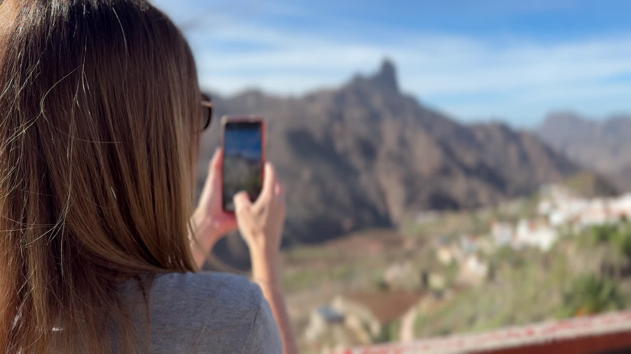 Tourist taking pictures of Roque Bentayga from Tejeda town in Gran Canaria, Canary Islands, Spain