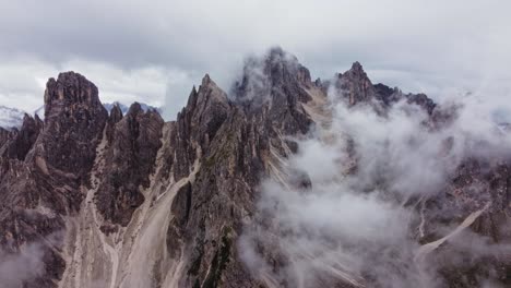 orbit drone shot of cadini di misurina in dolomites, italy on cloudy day