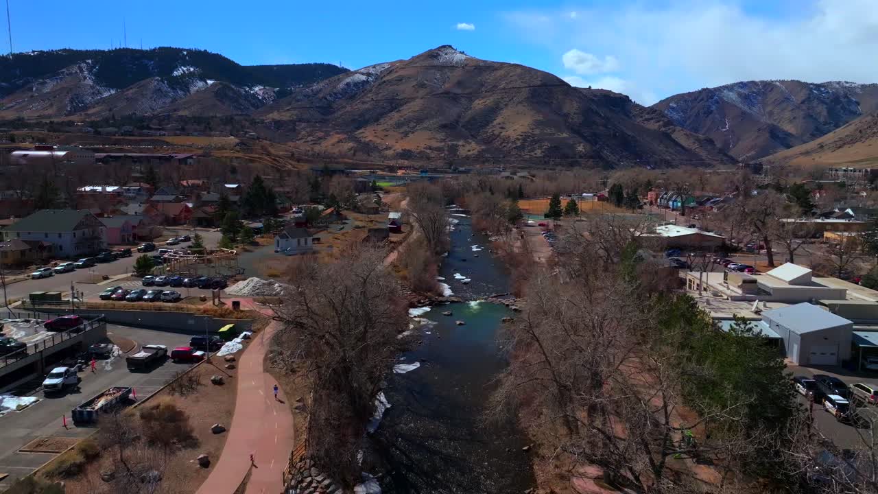 Downtown Golden Colorado aerial drone Clear Creek River trail waterpark Golden Gate Canyon Grange bridge winter sunny snow fishing North Table Mountain Coors Factory upstream forward motion