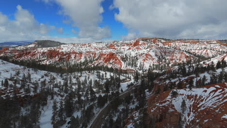 red rocks under snow during winter in sedona, arizona, usa - aerial drone shot