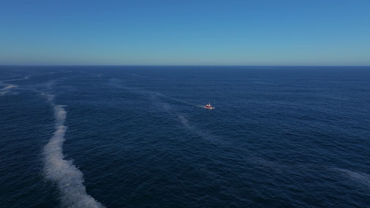 Aerial View of Fishing Boat Catching Fish In The Blue Sea.