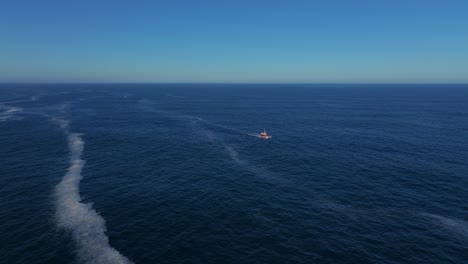 aerial view of fishing boat catching fish in the blue sea.