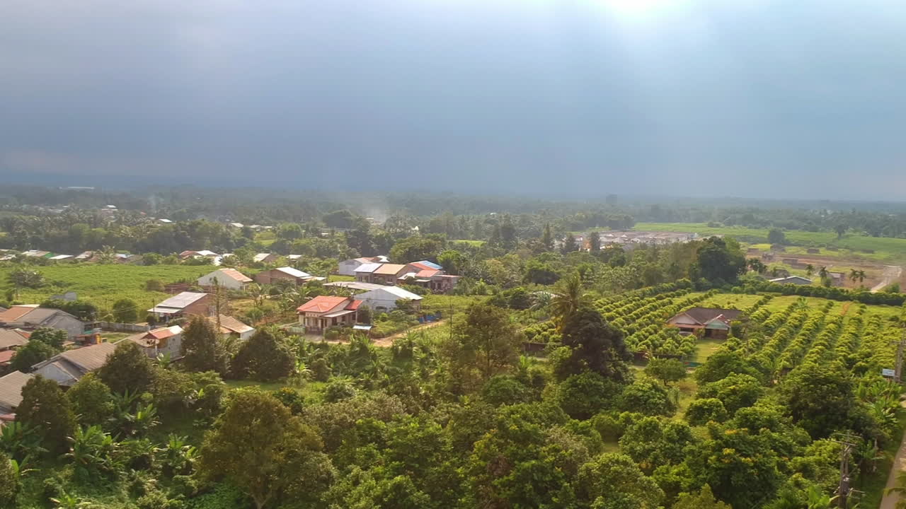 Aerial view of countryside area with farm houses and green trees