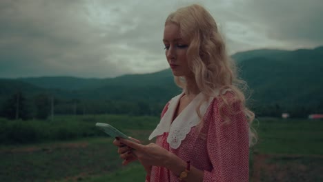 woman using phone in a rural setting