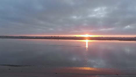 aerial view during sunrise of a small village on a natural reserve and it´s river