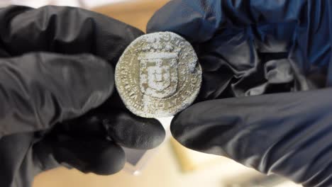 collector examining ancient royal seal