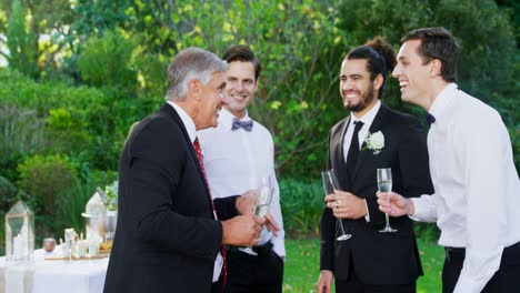 Father-of-the-Bride-having-champagne-with-groom-and-guest-4K-4k