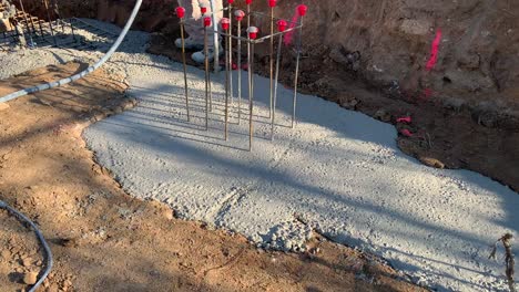 construction worker pouring concrete foundation