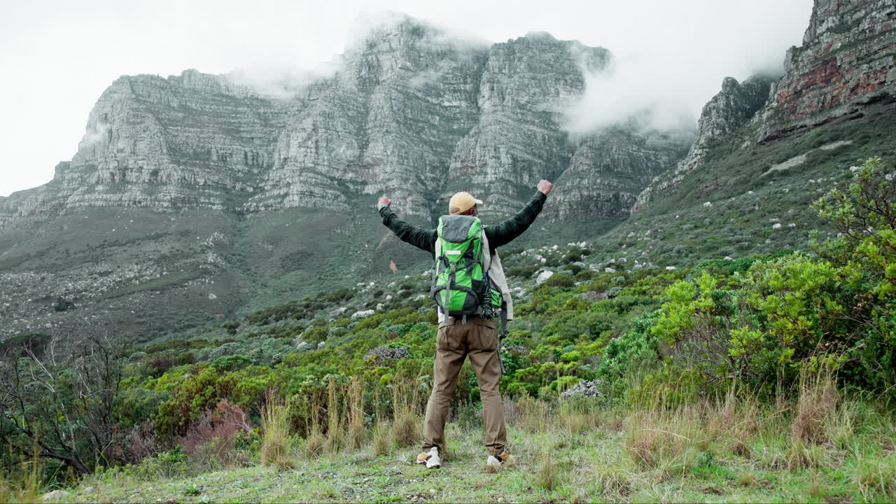 Hiker celebrating success in the mountains
