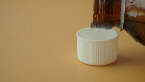 white bottle cap and medicine bottle