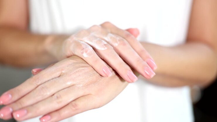 Moisturizing hands with cream