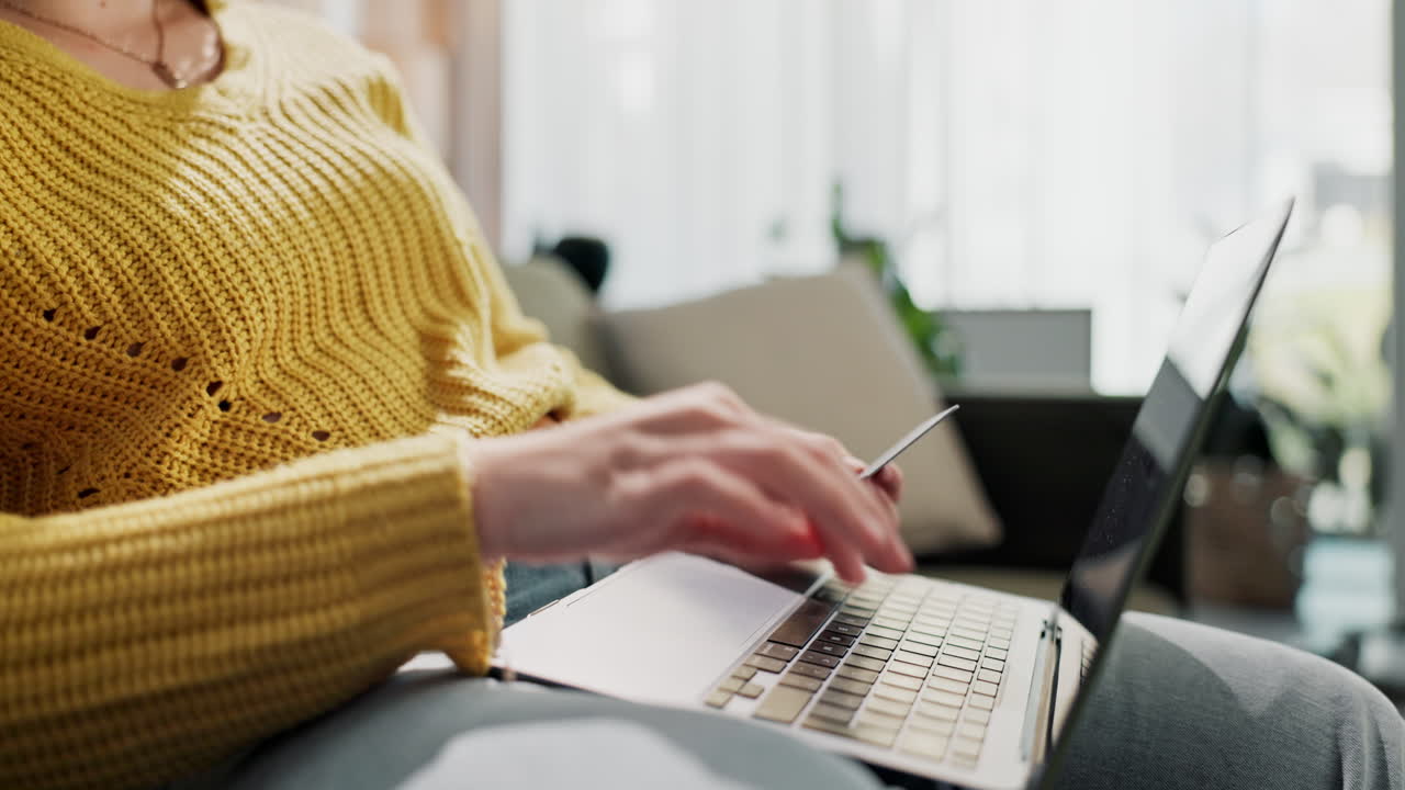 Woman shopping online with laptop and credit card at home
