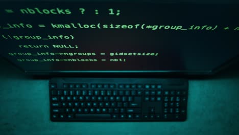 computer screen showing programming code and keyboard