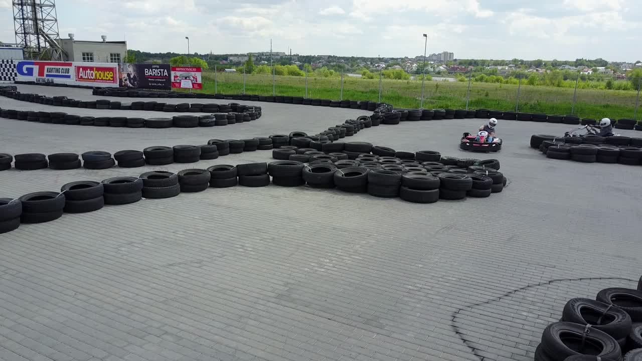 Driver In Helmet On Kart Circuit. VINNITSA, UKRAINE - MAY 2017: Europe Day, drivers in karts wearing helmet, racing suit participate in kart race