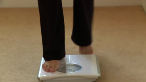 Close-up-of-a-woman-checking-her-weight