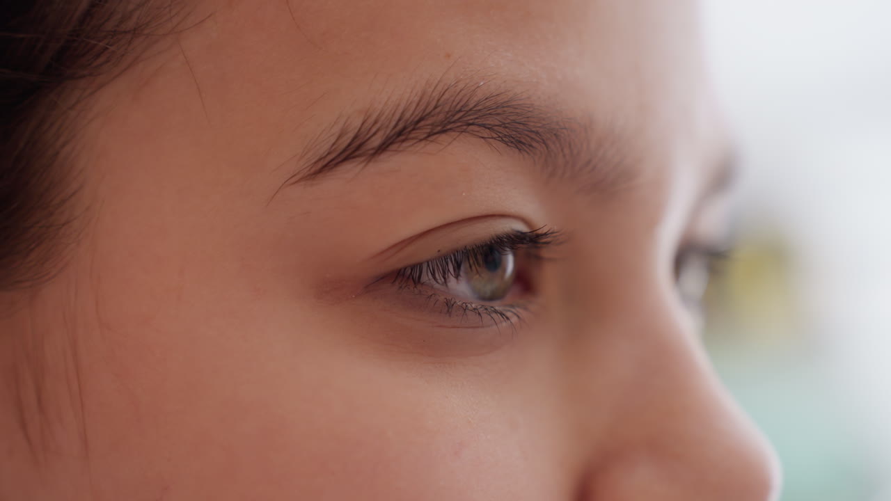 Refined Beauty Routine In Softly Lit Room, Woman Carefully Removing Eye Patch Near Mirror With Detailed Focus, Delicate Facial Grooming Performed By Young Woman Under Gentle Bathroom Lighting