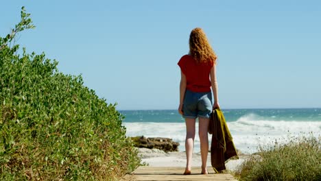 Woman-looking-at-sea-on-sunny-day--4k