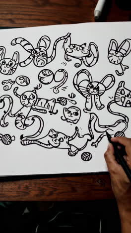 drawing whimsical cartoon cats and doodles with a marker