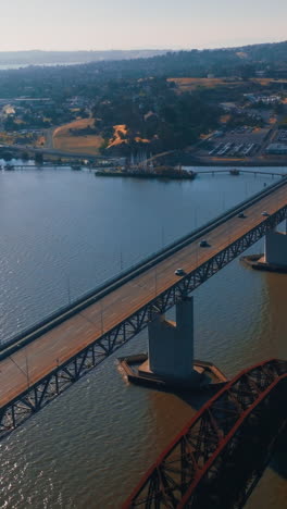 flying over the bridges leading to martinez, california, usa. beautiful american city scenery at sunny daytime. aerial view. vertical video