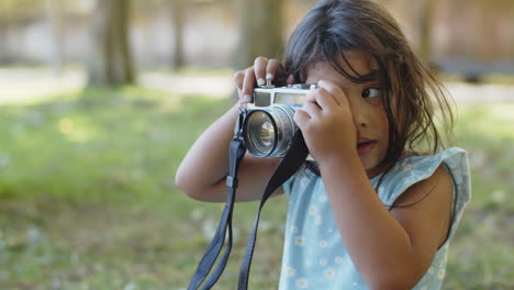 portrait of happy asian little girl smiling and playing with camera