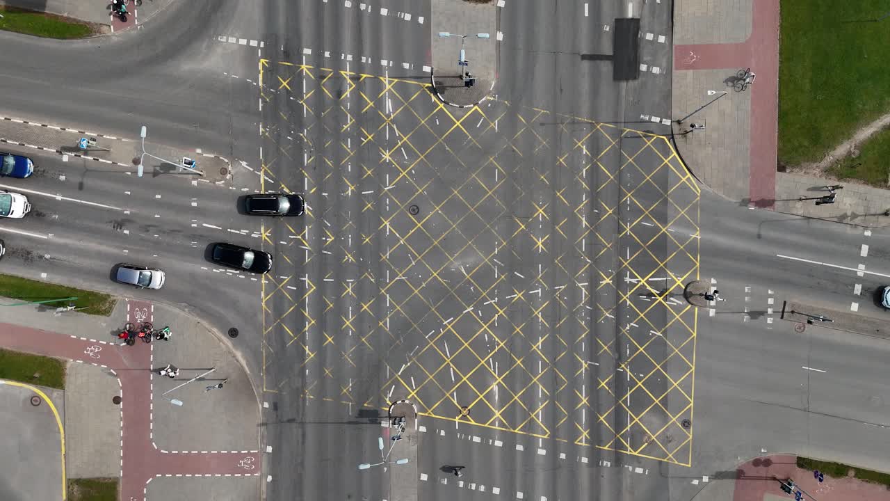 Aerial view of busy intersection with yellow grid road markings