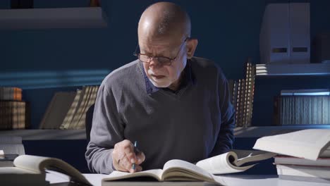 wise old man reading a book, researching historian mature man.