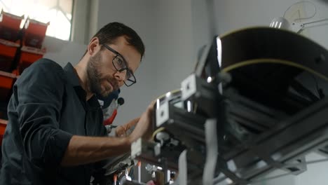man repairing a guitar in a workshop