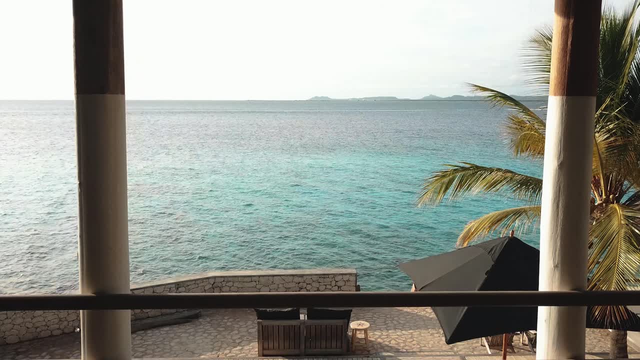 Drone passing through a window and heading out to sea