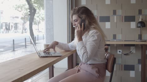 positive female entrepreneur talking on cellphone