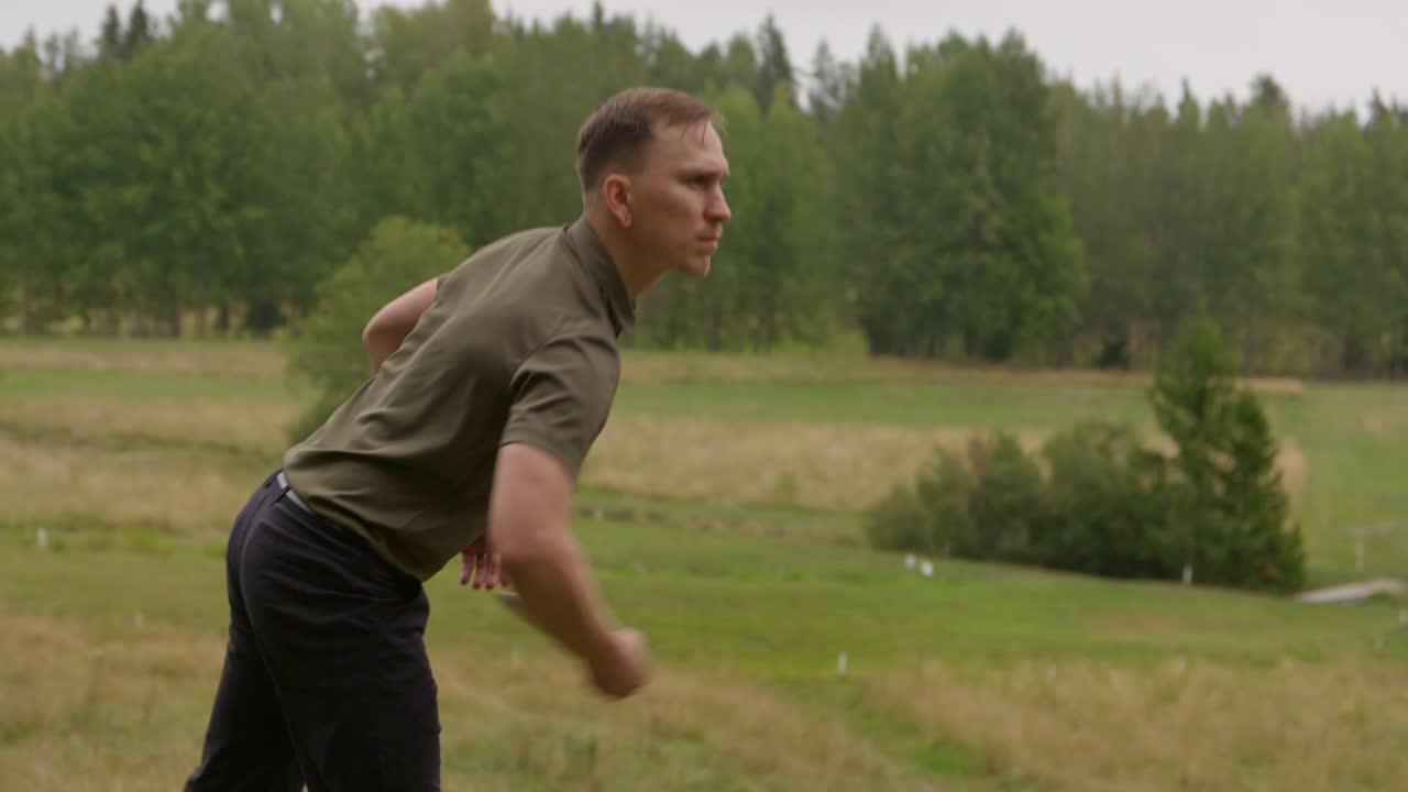 Disc golfer putts - medium shot