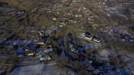 Drone-view-of-community-in-valley-below-mountains