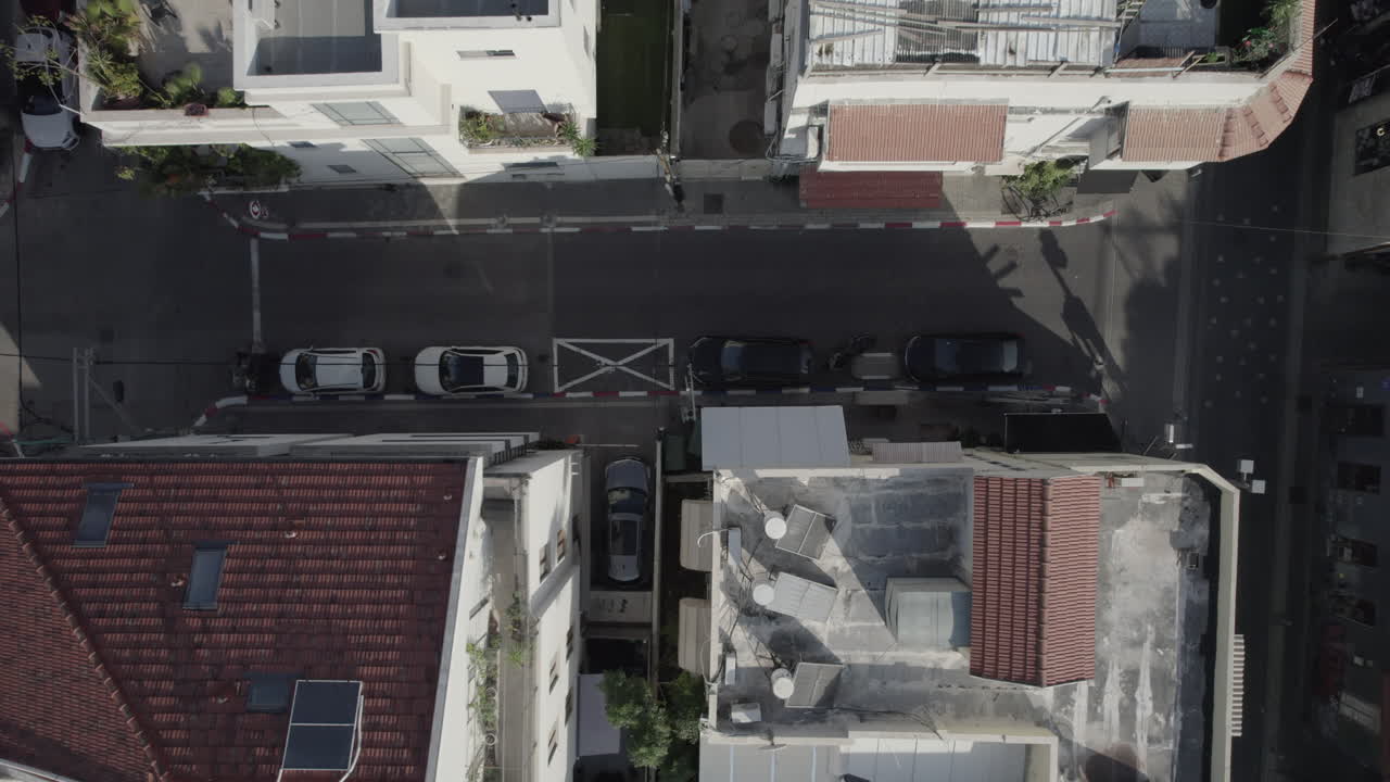 Aerial Top-Down View of Urban Rooftops and Streets