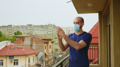 cheerful man with mask clapping