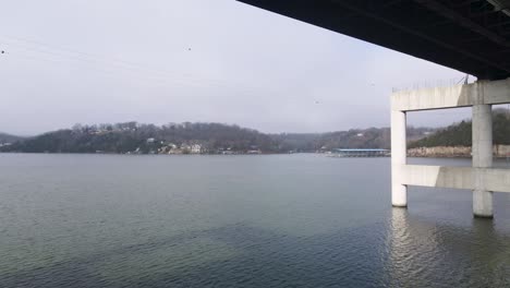 Aerial-Flying-Under-Toll-Bridge-Crossing-Ozarks-Lake,-Missouri