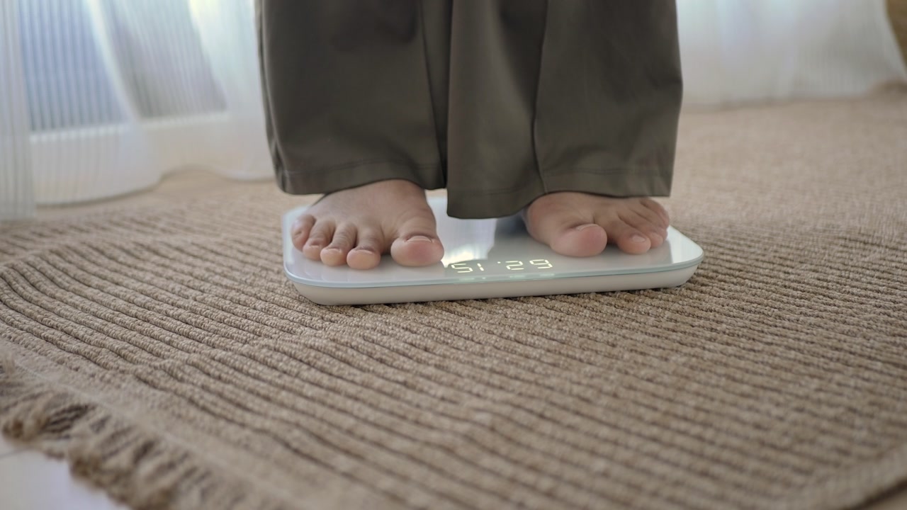 Person Steps on Smart Scale to Measure Weight