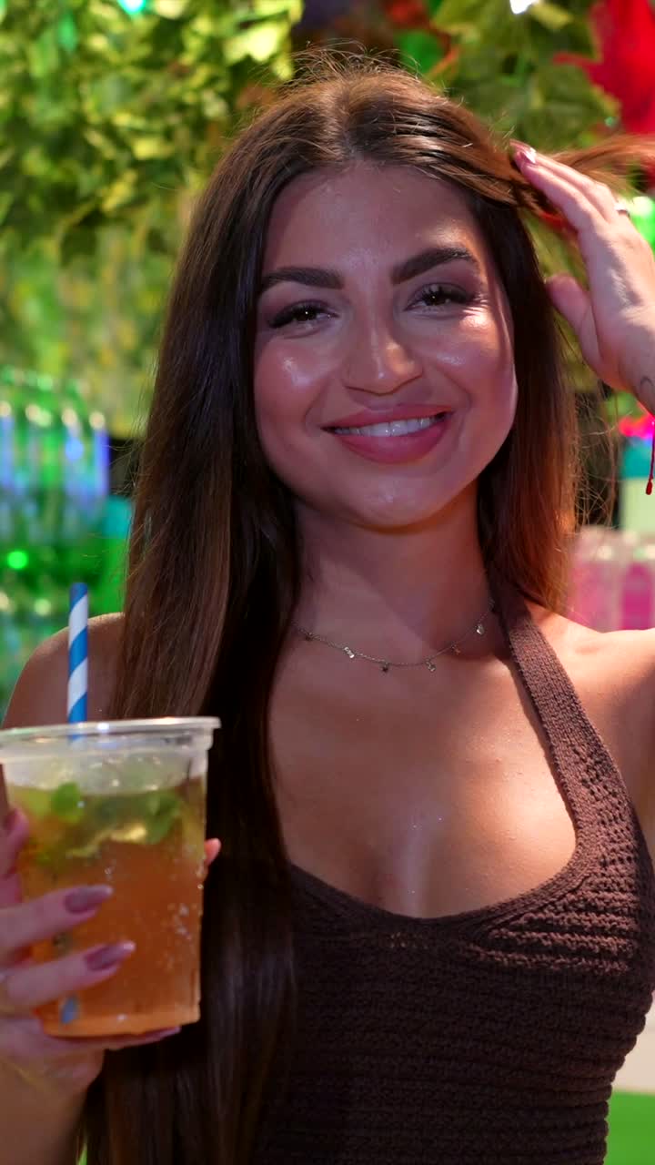 Brunette woman portrait holding cocktail