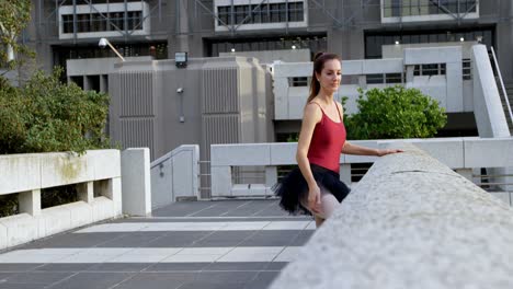 Ballet-dancer-stretching-on-pavement-4k