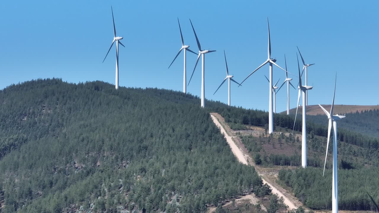 Rotating wind turbines standing on a hill in Portugal