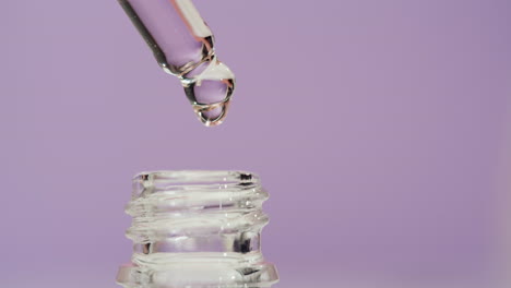 dropper dispensing liquid into a bottle