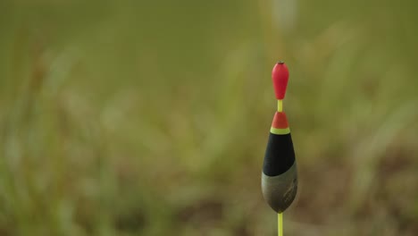 fishing bobber floating in the water with blurred background