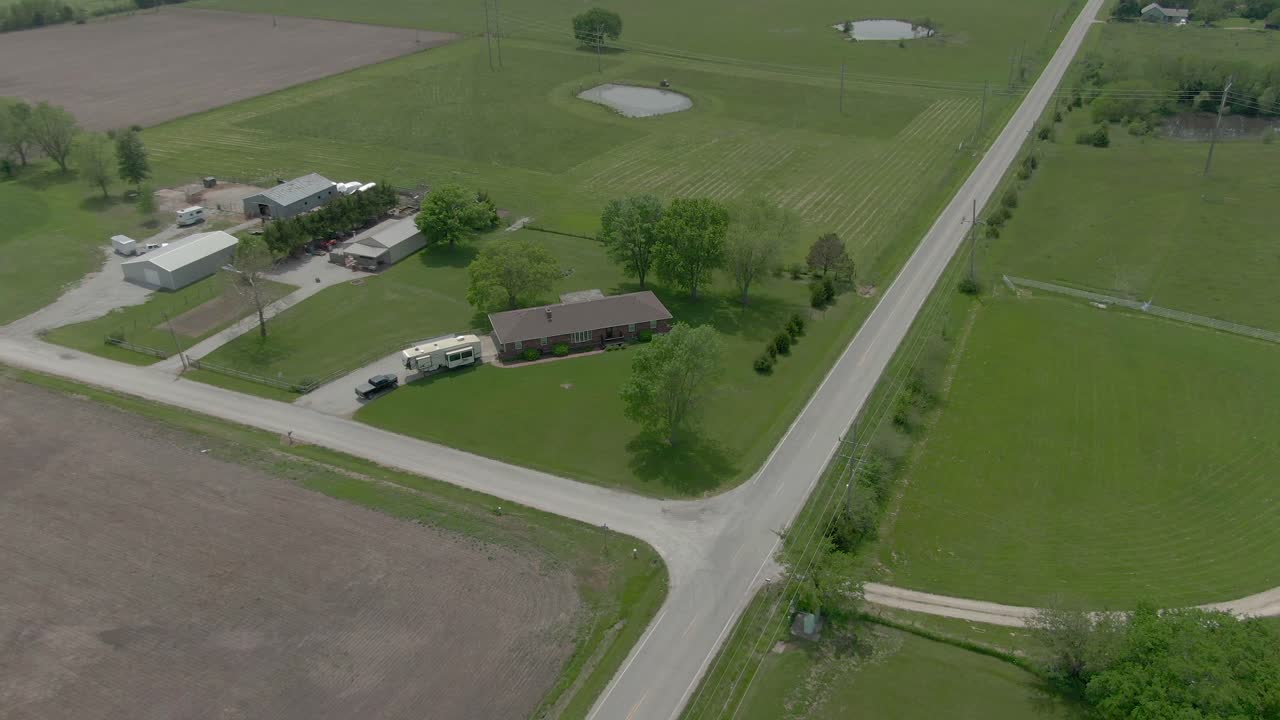 Aerial view pans around Country home in Kansas