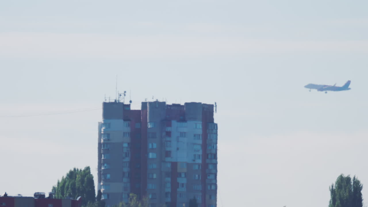 Passenger airplane approaching for landing over residential buildings
