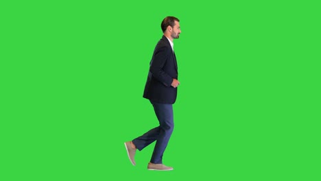 handsome running businessman in a white shirt and a suit on a green screen, chroma key