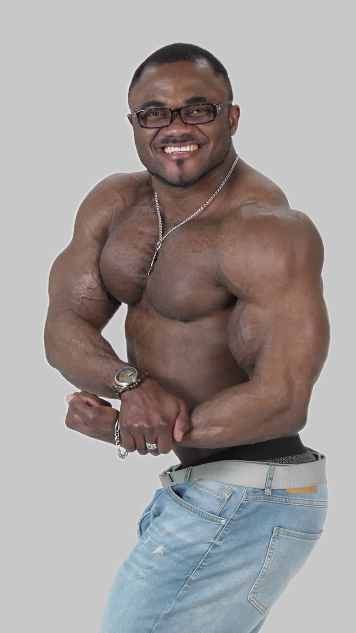 African male model posing shirtless. African male bodybuilder doing bodybuilding pose