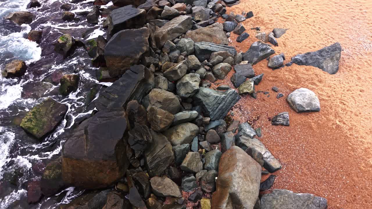 Stunning aerial view of rocky shoreline with waves crashing