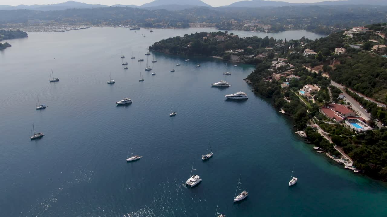 Drone view of corfu island with boats at komeno bay