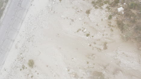 aerial top down view of a mountain slope meets the windy road