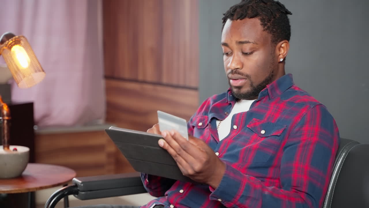 Man using tablet and credit card for online shopping