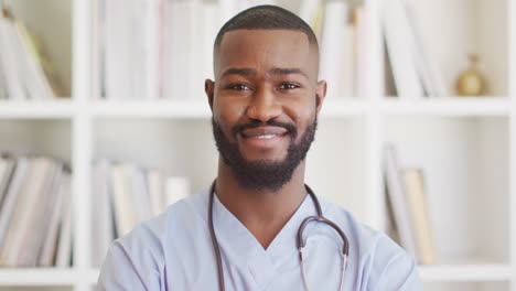 video of happy african american male doctor looking at camera
