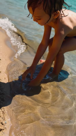 child playing in shallow water at the beach
